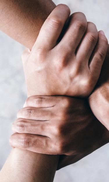 three people holding hands